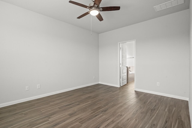 unfurnished room with a ceiling fan, dark wood finished floors, visible vents, and baseboards