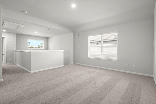 empty room with attic access, visible vents, baseboards, light colored carpet, and recessed lighting