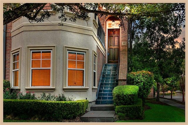 view of exterior entry at dusk