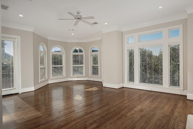 unfurnished living room featuring dark hardwood / wood-style flooring, ornamental molding, and ceiling fan