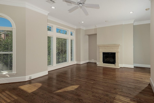 unfurnished living room featuring crown molding, ceiling fan, dark hardwood / wood-style floors, and a tiled fireplace