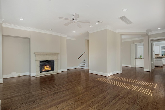 unfurnished living room featuring ceiling fan, ornamental molding, and dark hardwood / wood-style flooring