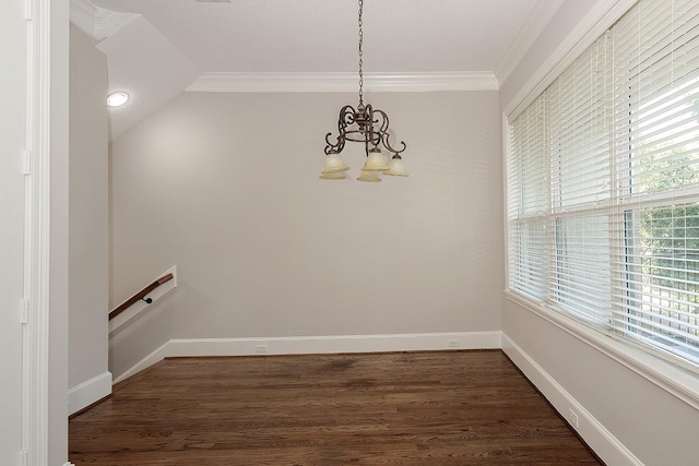 unfurnished dining area with a notable chandelier, ornamental molding, and dark hardwood / wood-style floors