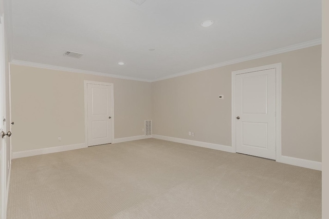 carpeted empty room featuring crown molding