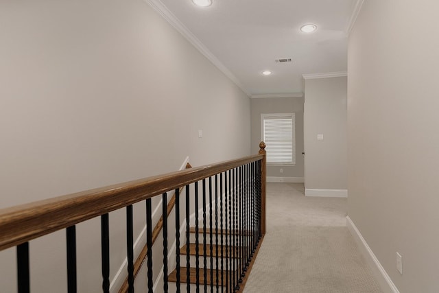 hall with ornamental molding and light carpet