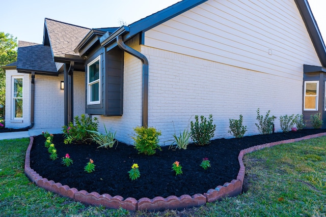 view of property exterior with a lawn