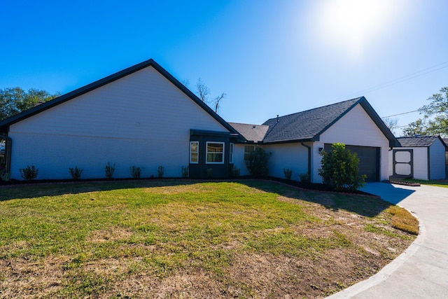 view of side of home featuring a garage and a lawn