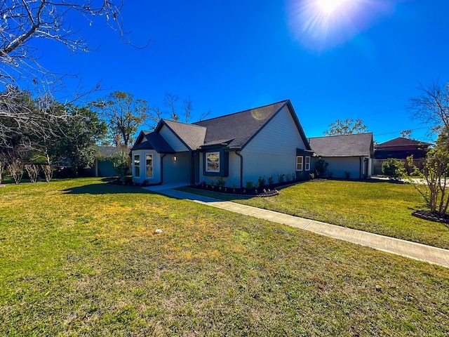 ranch-style home featuring a front yard