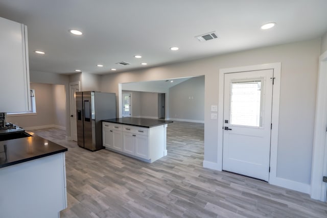 kitchen featuring white cabinetry, stainless steel fridge, and light hardwood / wood-style flooring