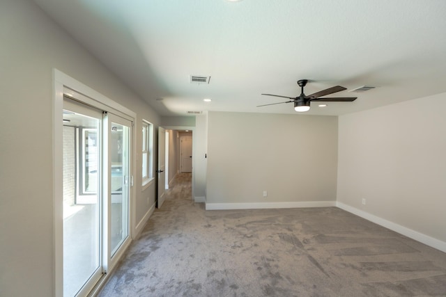 carpeted empty room featuring ceiling fan