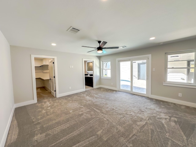 unfurnished living room featuring carpet floors and ceiling fan