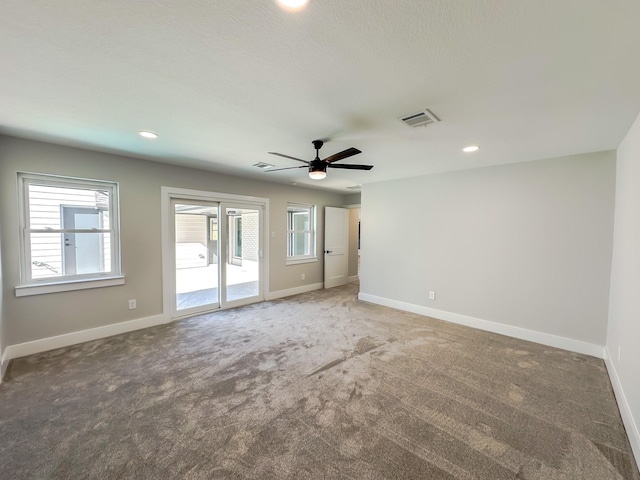 unfurnished room with ceiling fan and carpet