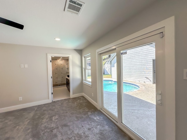 doorway featuring dark carpet