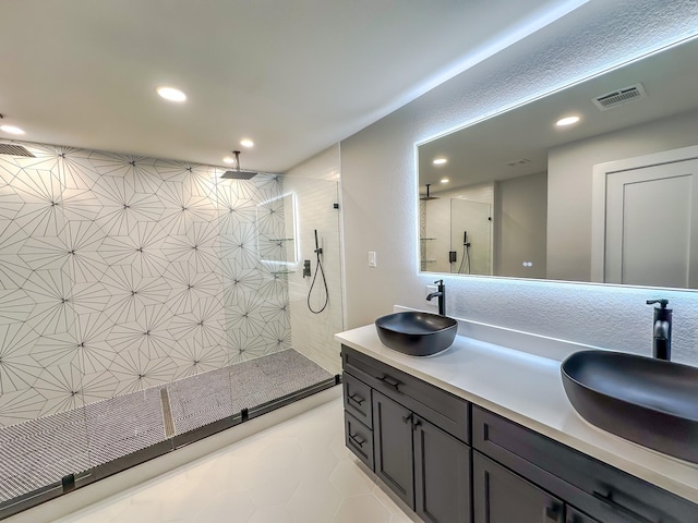 bathroom with vanity and tiled shower