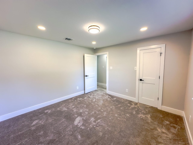 unfurnished bedroom featuring dark colored carpet