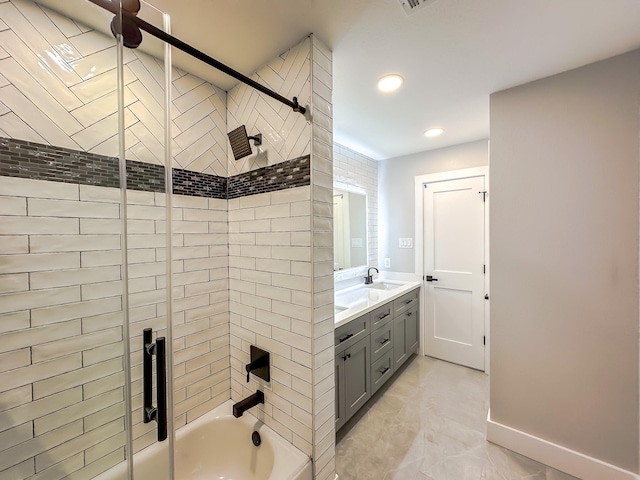 bathroom featuring vanity and tiled shower / bath