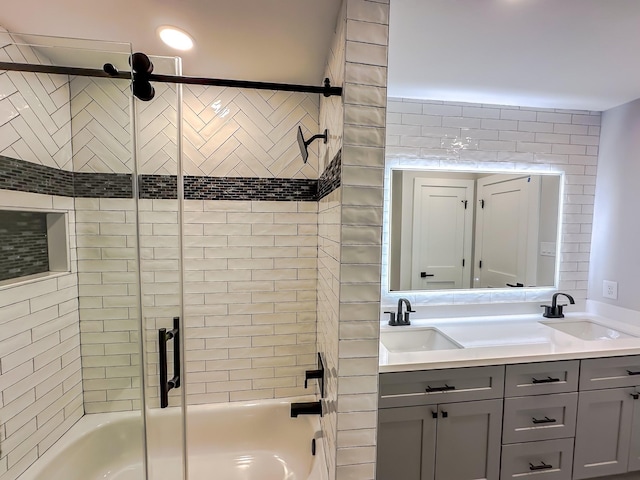 bathroom featuring bath / shower combo with glass door and vanity