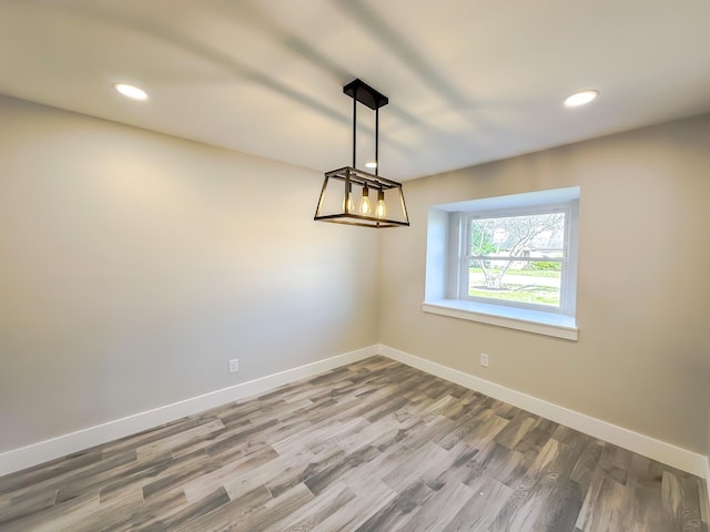 unfurnished room featuring hardwood / wood-style flooring