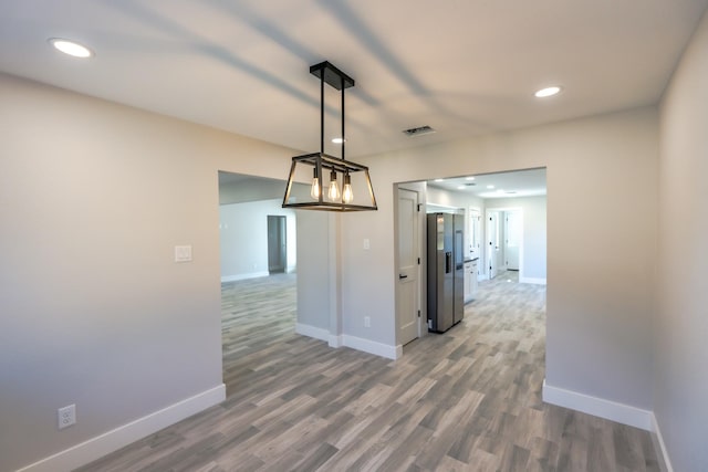 unfurnished dining area featuring hardwood / wood-style flooring