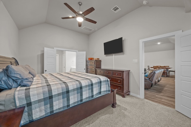 bedroom featuring lofted ceiling, light colored carpet, and ceiling fan