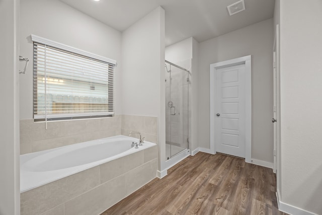 bathroom featuring independent shower and bath and wood-type flooring