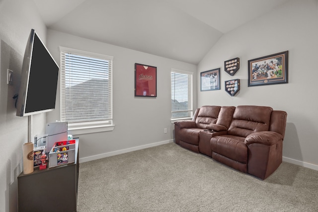 carpeted home theater room with lofted ceiling