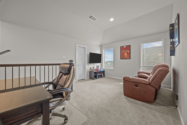 carpeted home office with vaulted ceiling