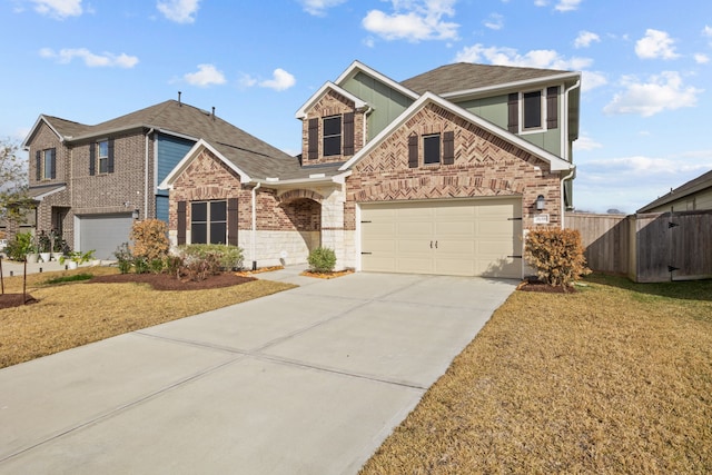 view of property featuring a garage and a front lawn