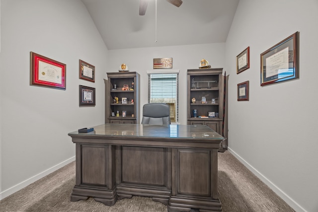 carpeted office with lofted ceiling and ceiling fan