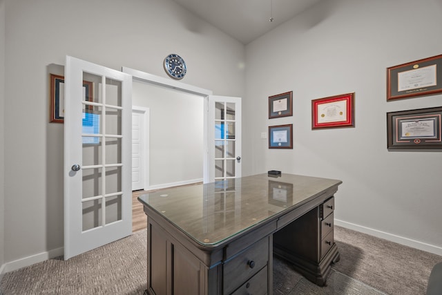 carpeted office featuring french doors