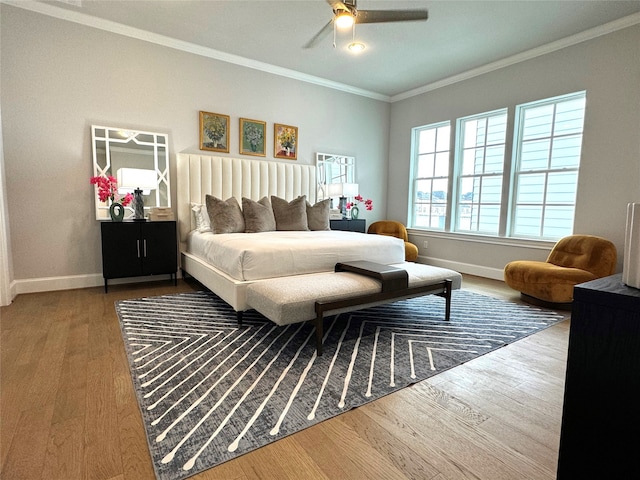 bedroom featuring crown molding, wood-type flooring, and ceiling fan