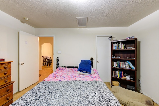 carpeted bedroom featuring a textured ceiling