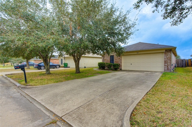 single story home featuring a garage and a front yard