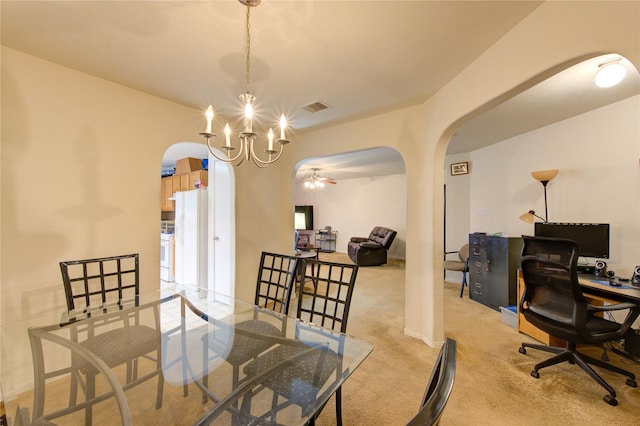 carpeted dining room featuring an inviting chandelier