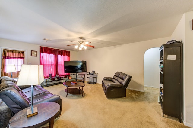 carpeted living room featuring a textured ceiling and ceiling fan