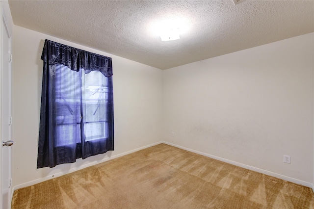 spare room with carpet floors and a textured ceiling