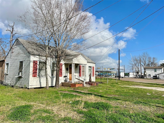 view of front of house featuring a front yard and cooling unit