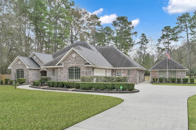 view of front of house featuring a garage and a front yard