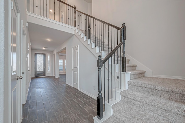 entrance foyer with dark hardwood / wood-style flooring and a high ceiling