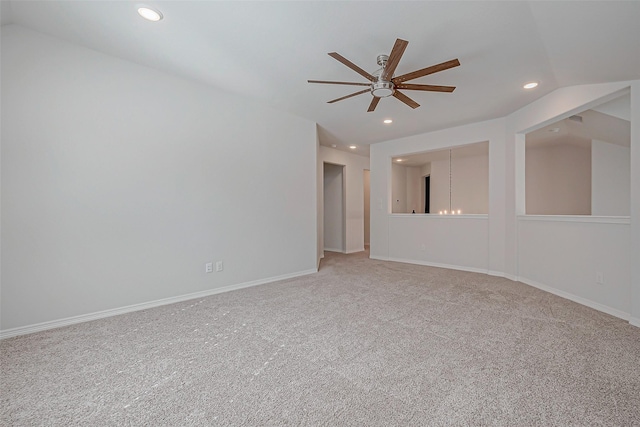 spare room featuring carpet floors, lofted ceiling, and ceiling fan