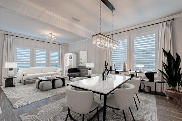 dining space with ornamental molding and a chandelier