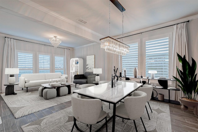 dining area with a notable chandelier and ornamental molding