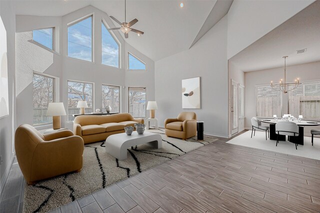 living room featuring ceiling fan with notable chandelier