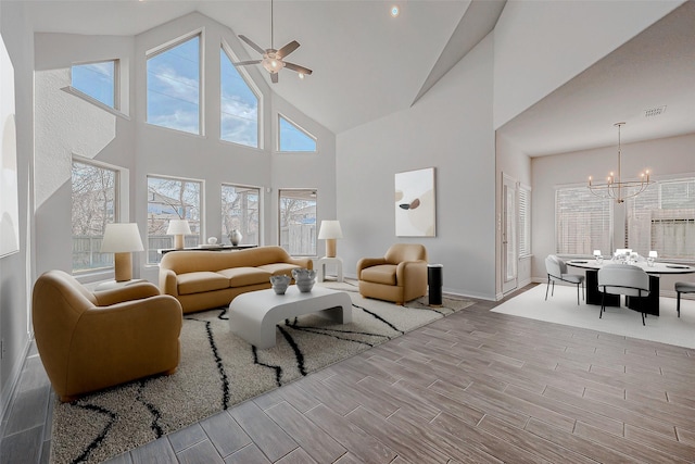 living room featuring ceiling fan with notable chandelier