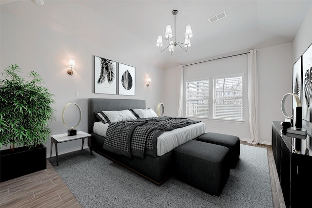 bedroom with a chandelier and light hardwood / wood-style flooring