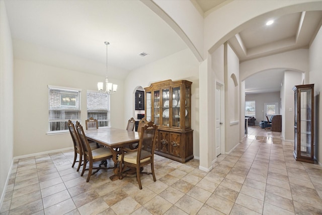 tiled dining room featuring a chandelier