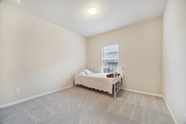 bedroom featuring light colored carpet