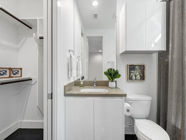 bathroom featuring vanity and toilet