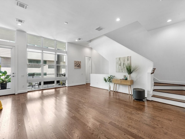 living room featuring a wall of windows and dark hardwood / wood-style flooring