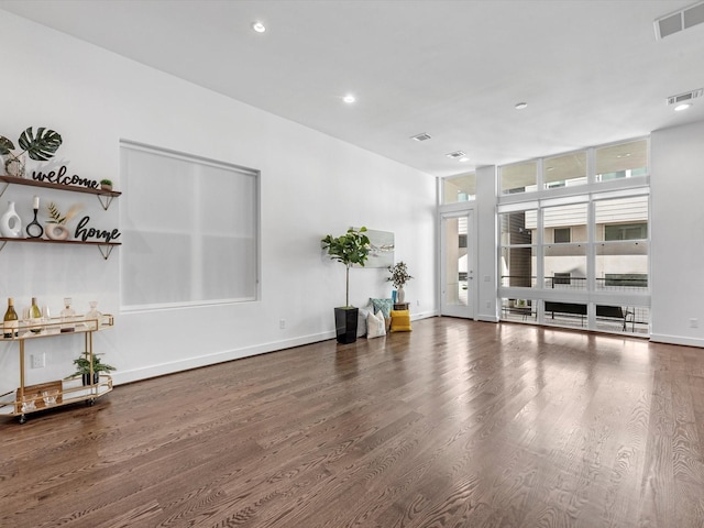 living room featuring dark wood-type flooring and floor to ceiling windows